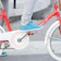 Close-up of a biker's foot wearing clean sneakers with the Ride Solex protector on the gear lever.
