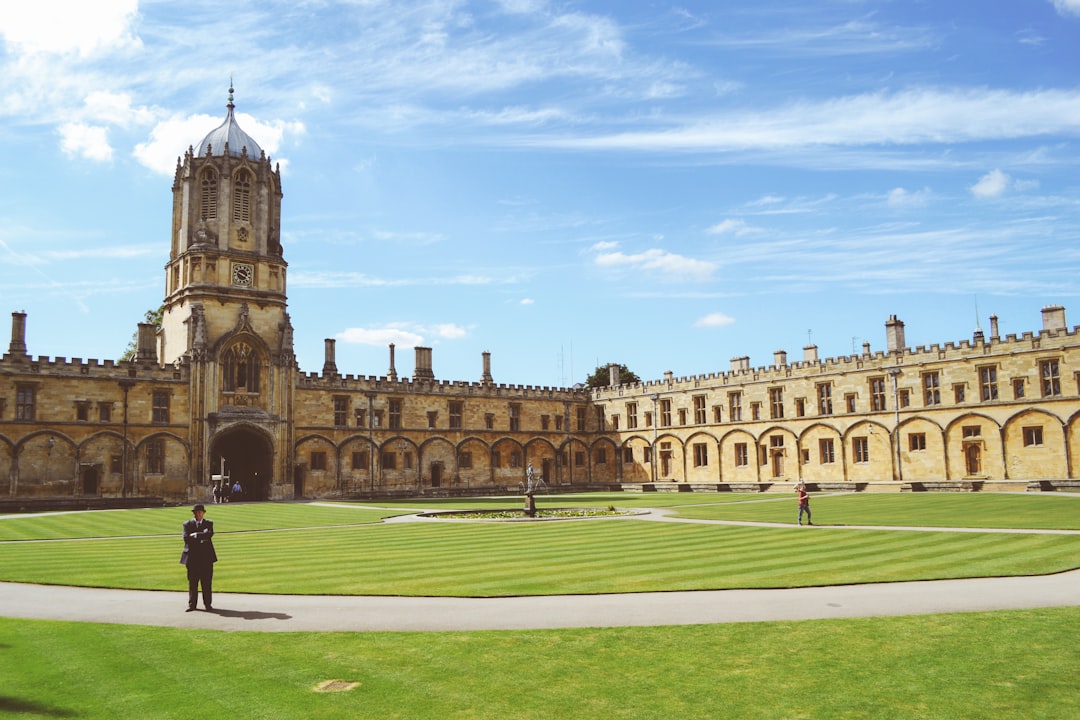 three person standing on university grass field