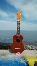 A cozy ukulele resting on a sunlit beach towel with palm trees swaying gently in the background.