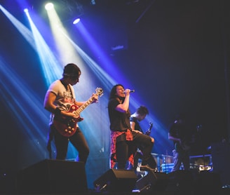 photo of male band performing on stadium