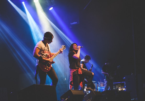 photo of male band performing on stadium