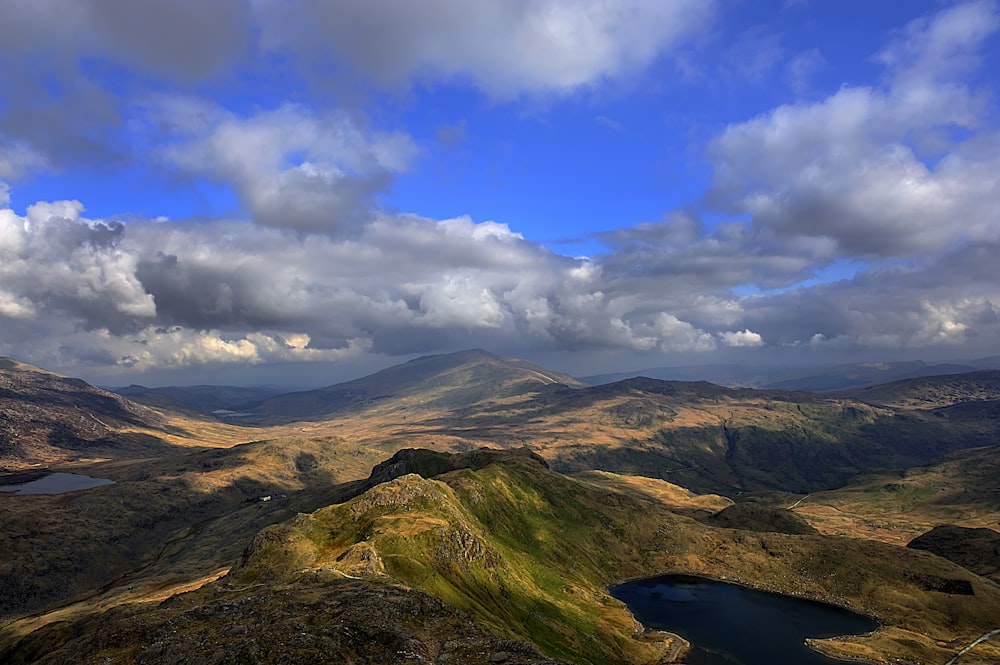 aerial photography of mountains near lake at daytime