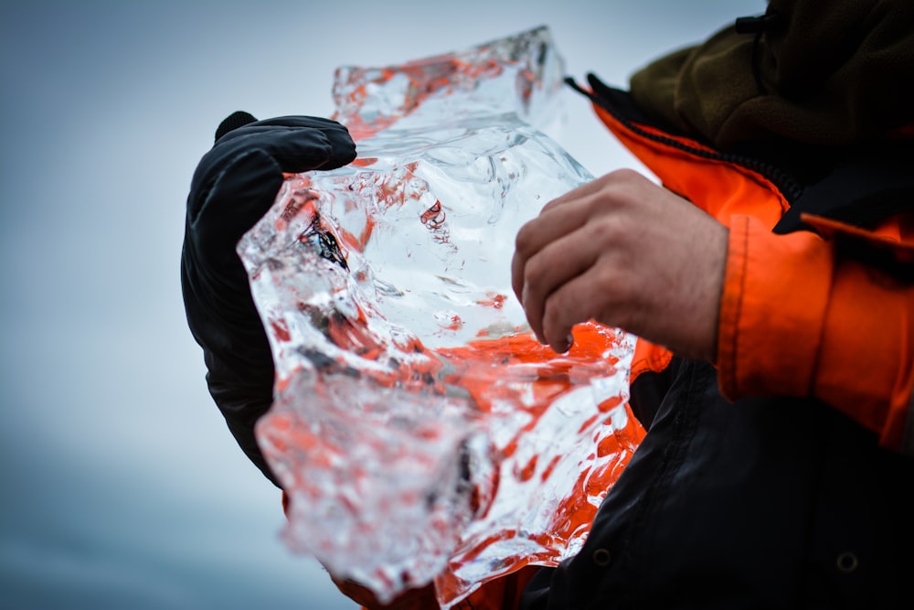 person holding clear crystal