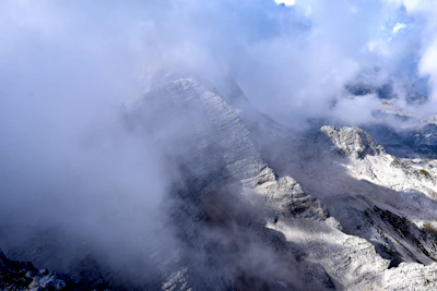 Close-up of rugged mountain rocks with morning mist weaving through.
