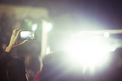 A dynamic shot of a person using a gadget with bright background lighting
