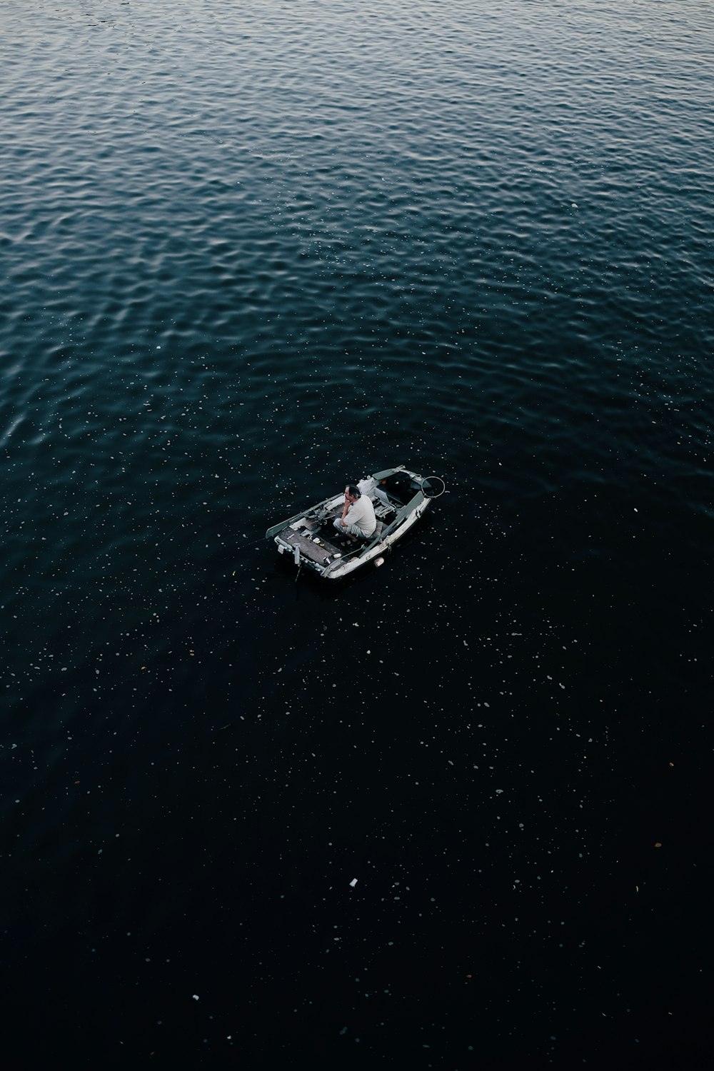 man in gray canoe boat