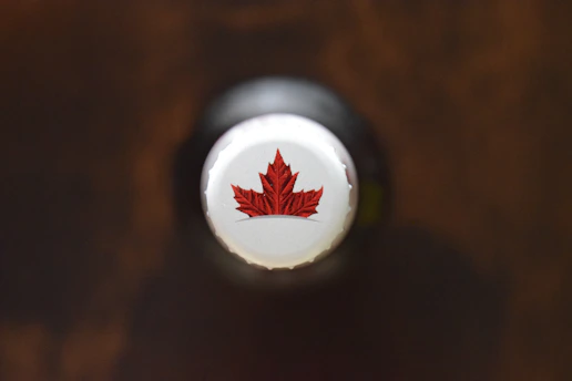 Close-up of Lipovita Track Pro bottle with Canadian maple leaf background.