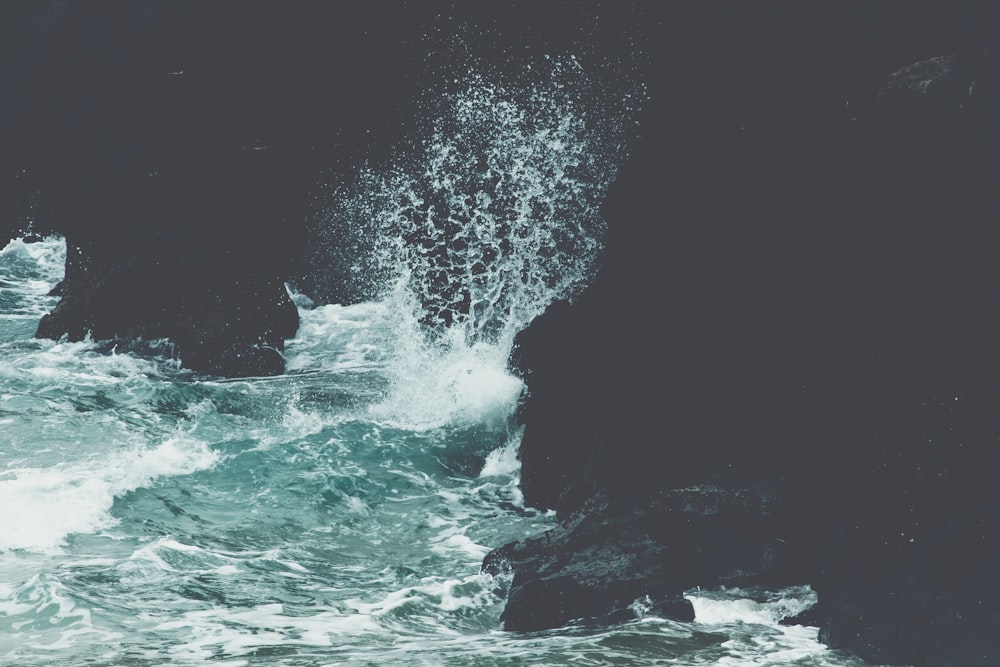 sea waves crashing on rocks
