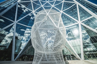 a large white sculpture in front of a building