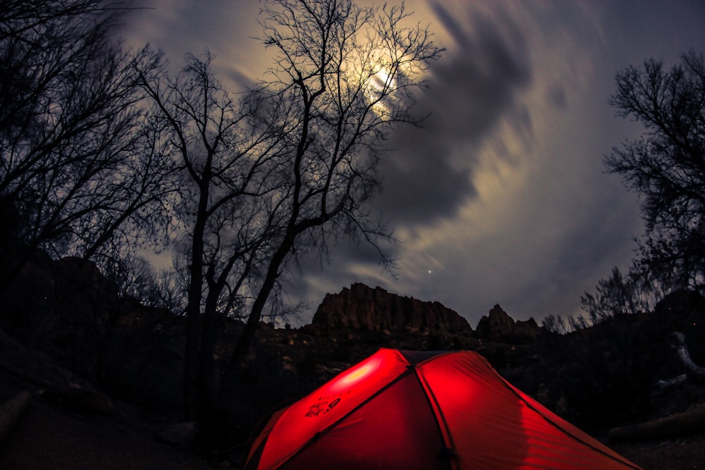 red tent on brown field under gray clouds