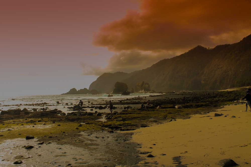 black mountain near sea under white sky during golden hour