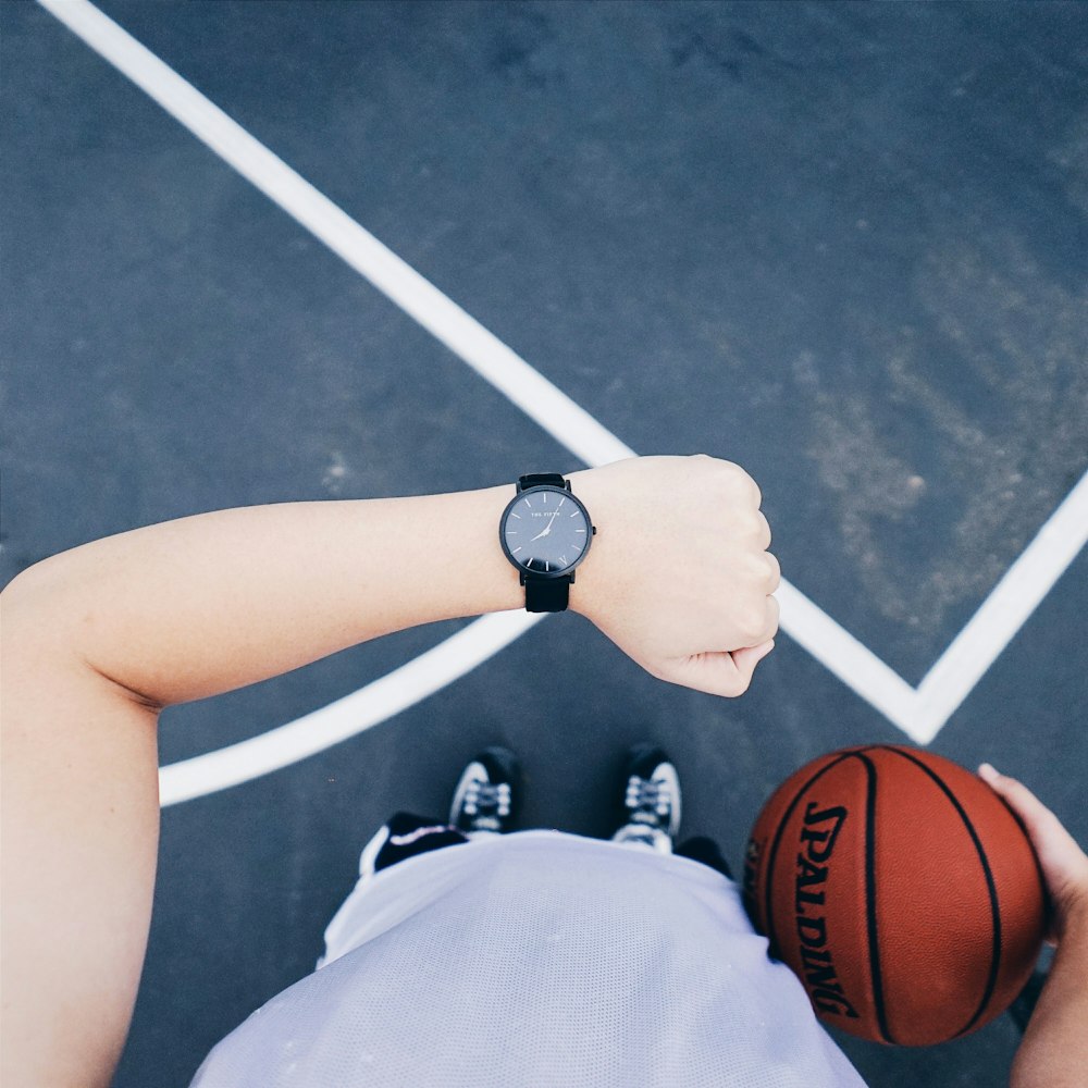 person wearing black analog watch