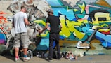 Diverse team members working on a reverse graffiti campaign.