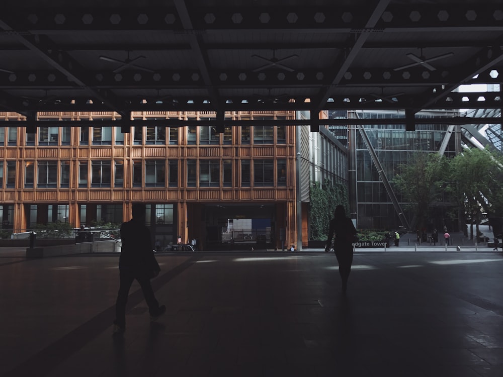 silhouette photo of woman and man walking