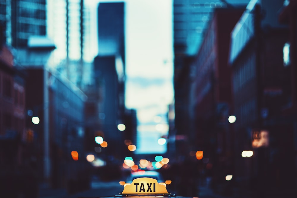 selective focus photography of taxi signage