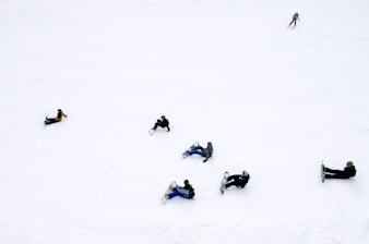 people playing snowboards