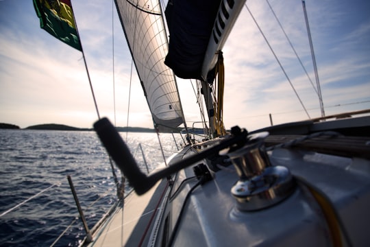 Reel on sailboat with sails sailing on water with horizon in the background in Hvar Croatia