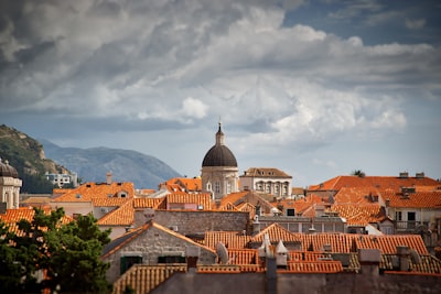 white concrete domed tower near houses at daytime croatia teams background