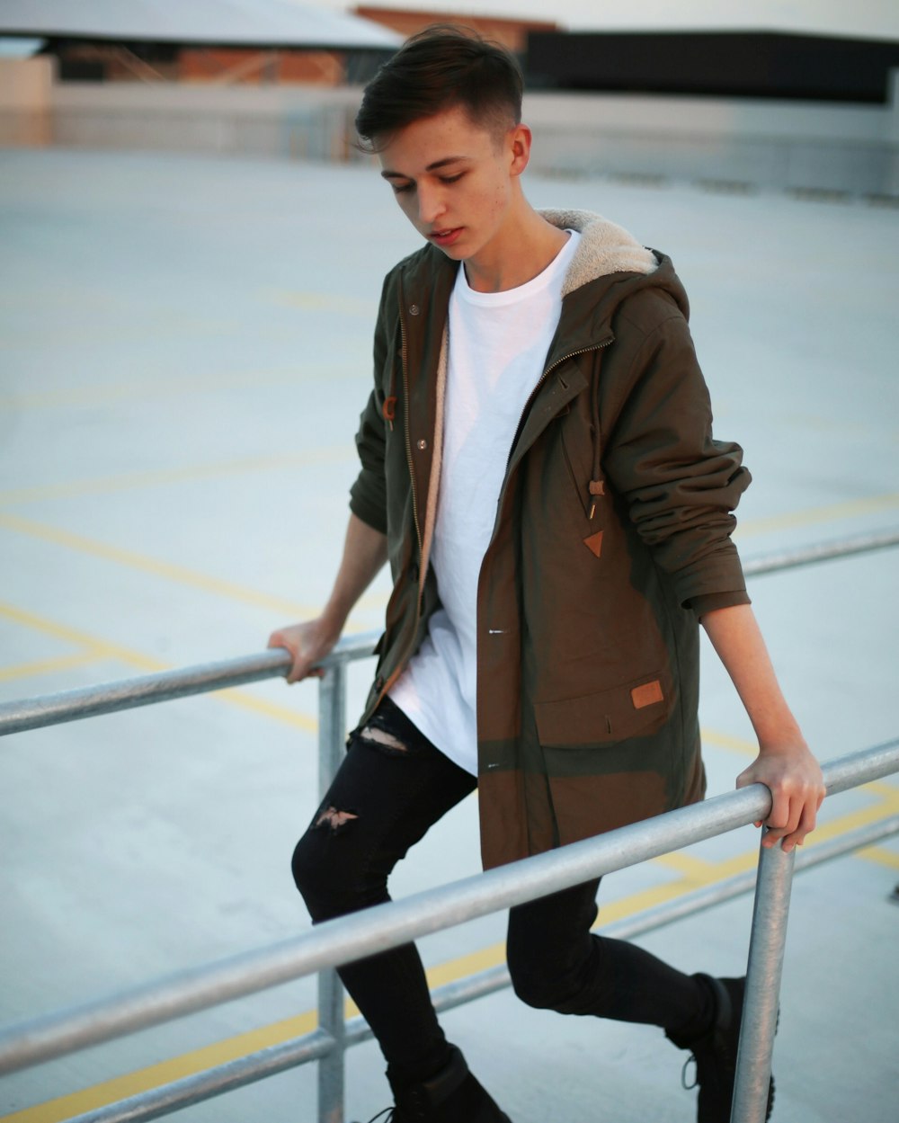 a young man is leaning on a railing