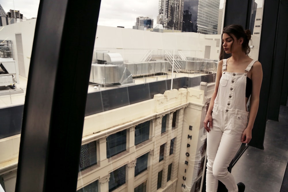 woman wearing white denim overalls