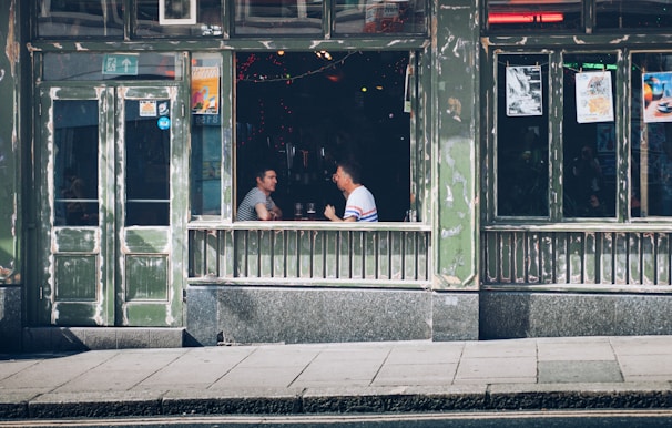 A casual conversation scene with two people practicing French in a café.