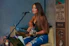 woman playing guitar while singing