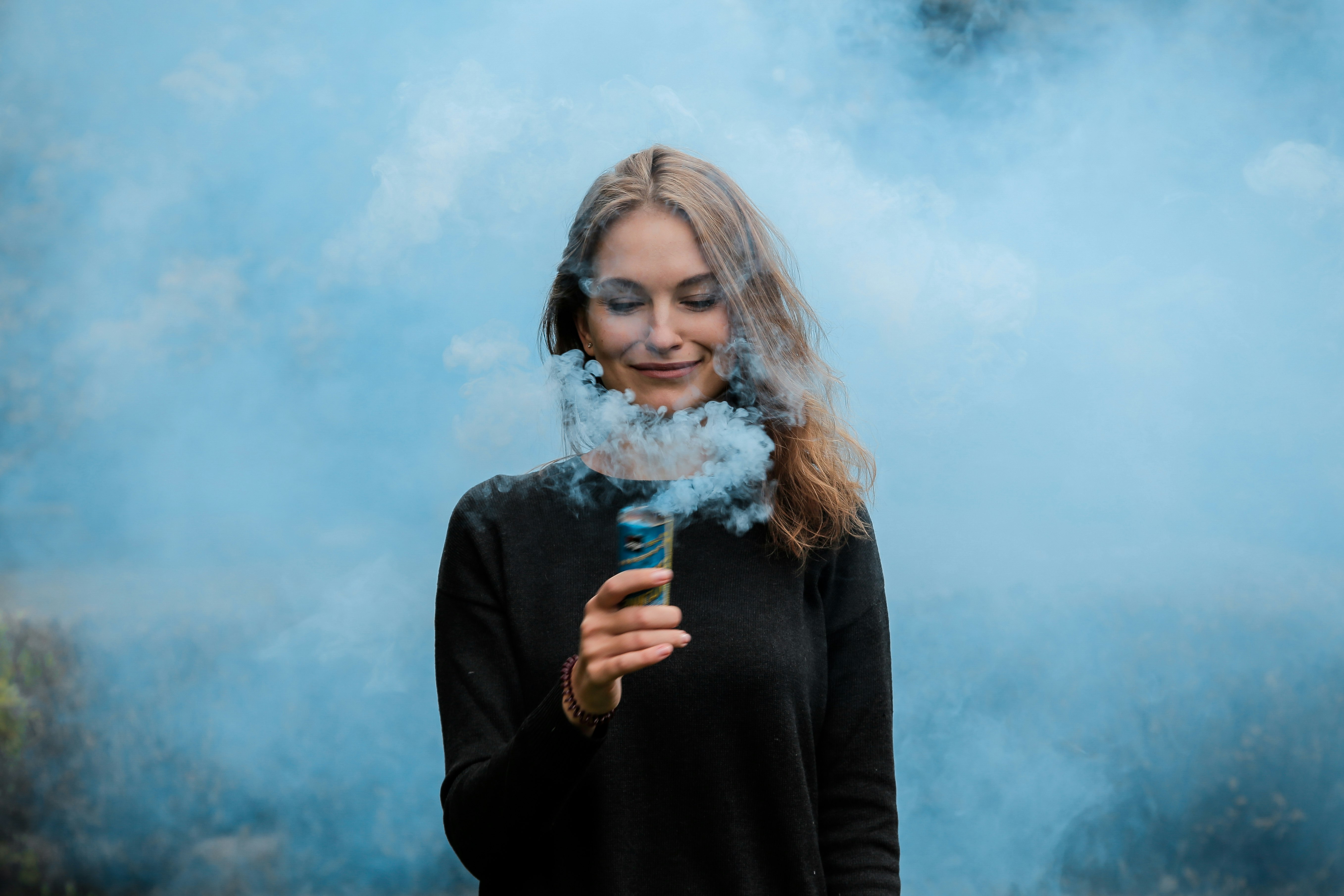 shallow focus photography of woman surrounded by smoke