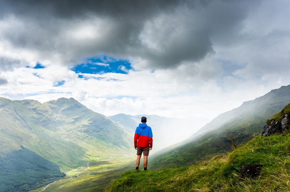 photography of man standing on green grass