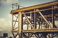 Finished steel structure installed on a construction site against a cloudy sky.