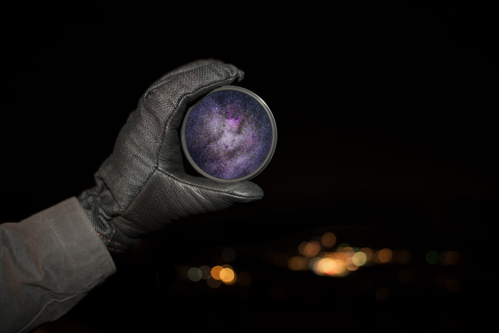 A person holding a lens filter with the galaxy and stars on it in Silverthorne