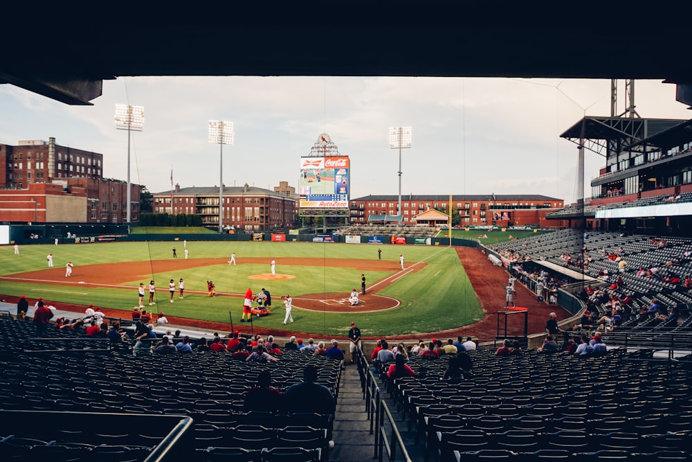 people watching baseball game during daytime