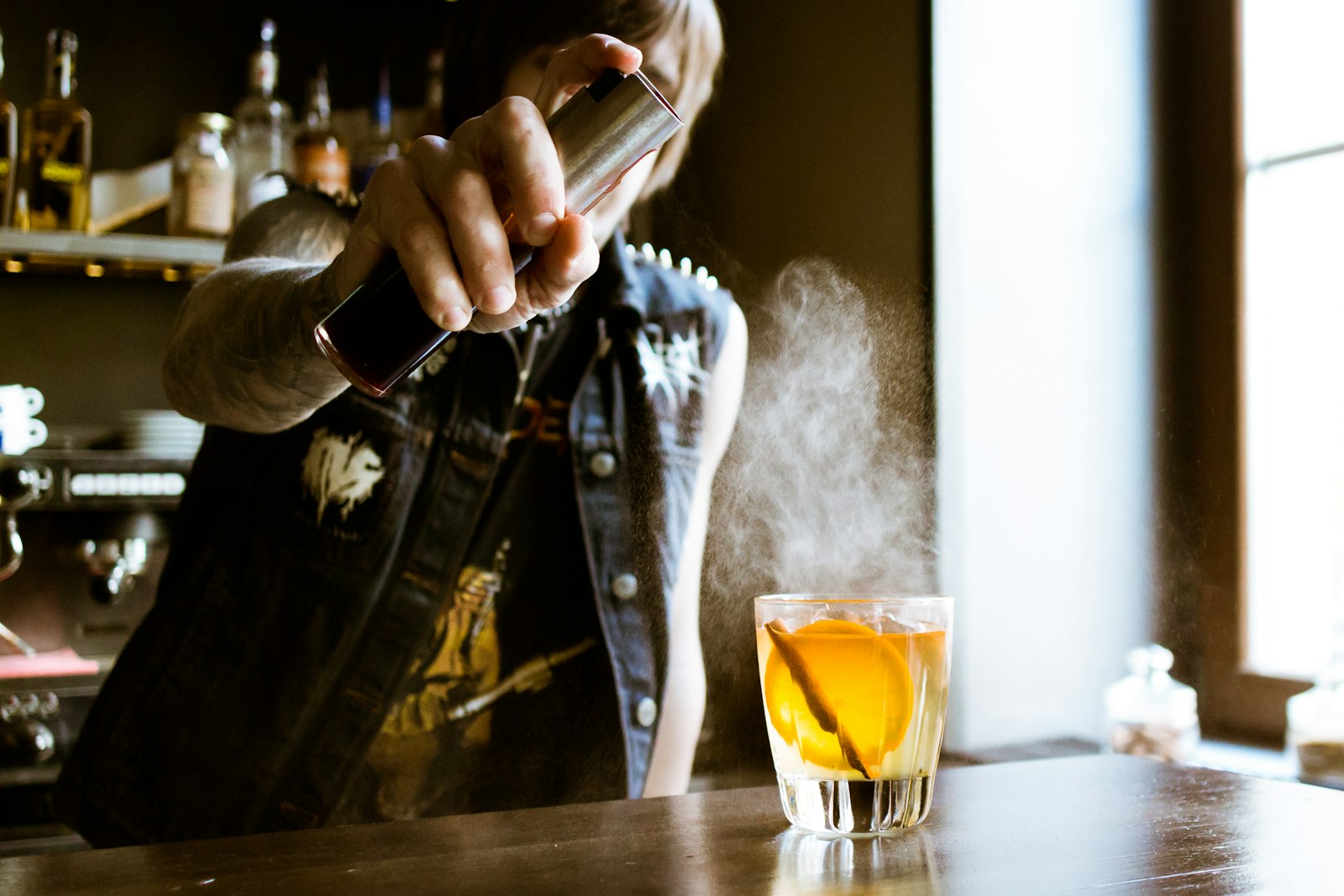 Canon EF 24mm F2.8 IS USM sample photo. Bartender holding spray bottle photography