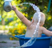 child lifting water dipper