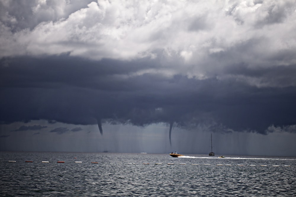 boat on sea under white clouds