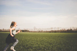 girl running on grass field