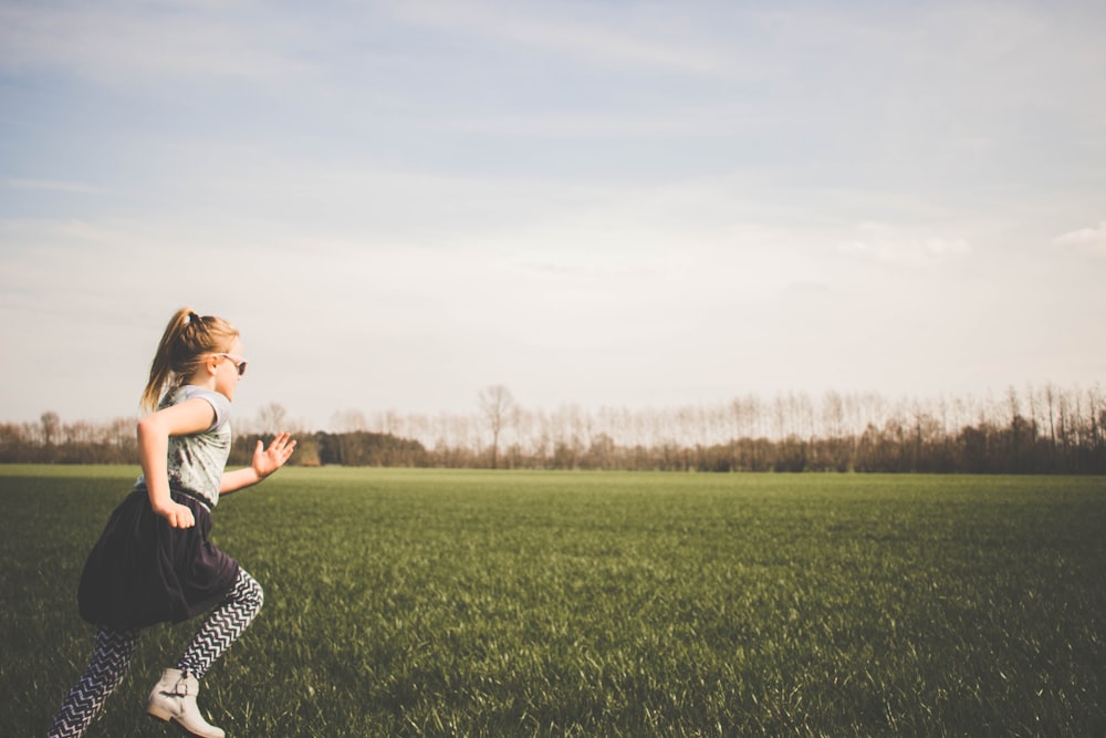 girl running on grass field
