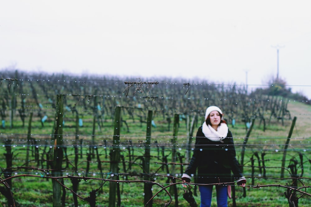 woman standing in front of fence