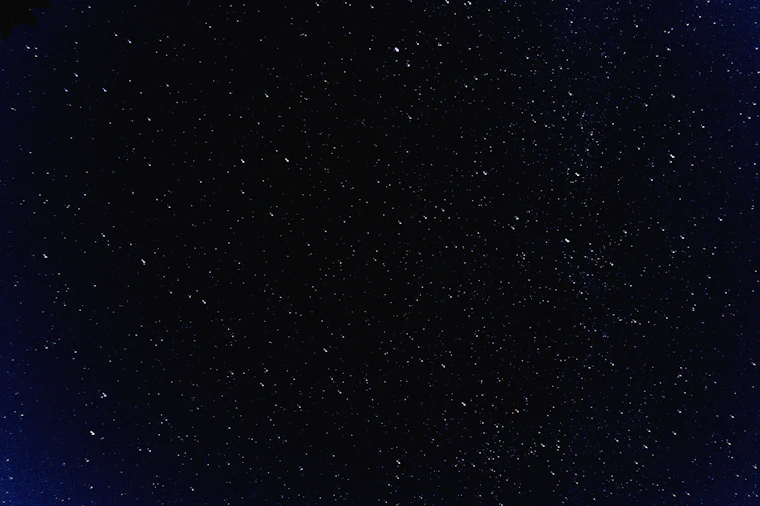 Night sky over a quiet ridge