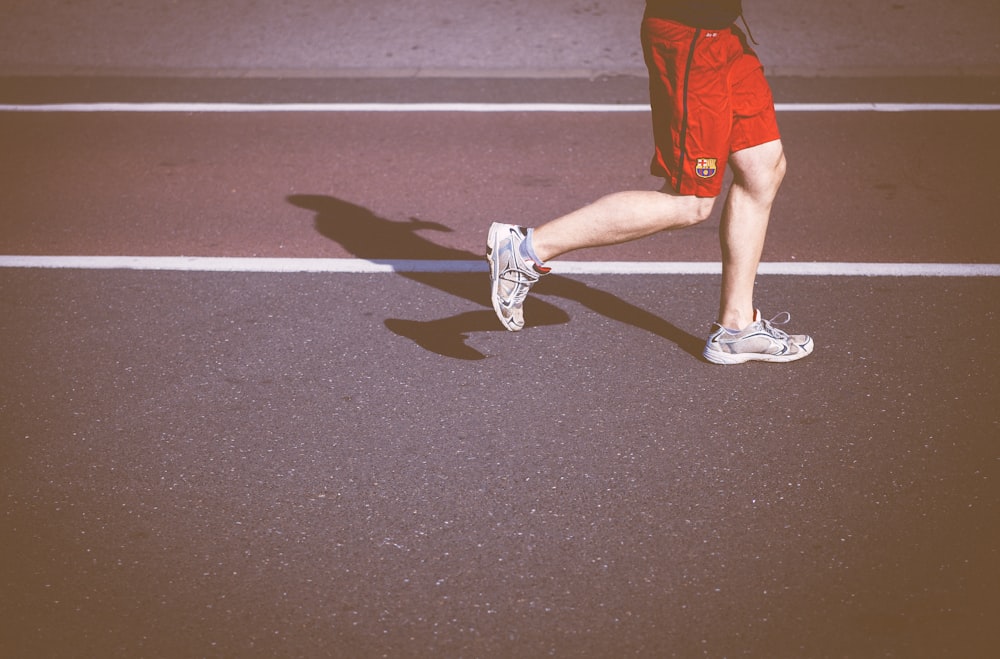 person running on concrete road