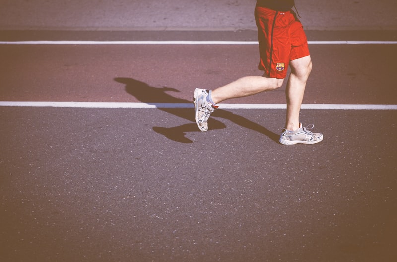 Runner stretching legs after workout wearing compression socks for faster muscle recovery