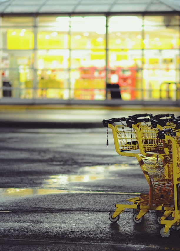 yellow shopping carts on concrete ground