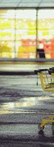 yellow shopping carts on concrete ground