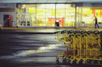 yellow shopping carts on concrete ground