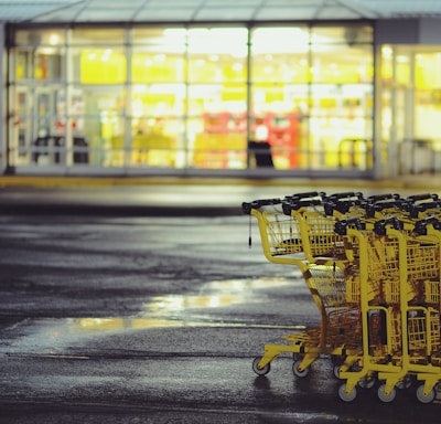 yellow shopping carts on concrete ground