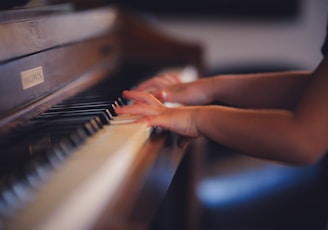 person playing upright piano