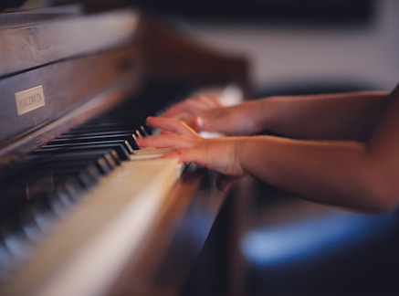 person playing upright piano