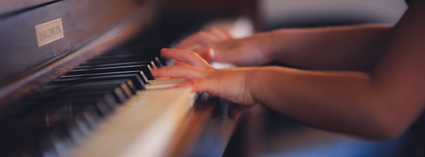 person playing upright piano