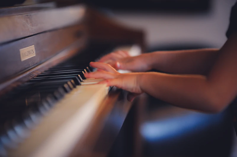 Child student practicing piano during a lesson