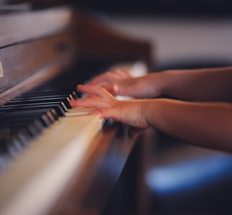 person playing upright piano