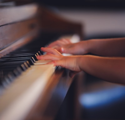 person playing upright piano